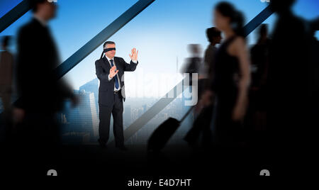 Composite image of mature businessman in a blindfold Stock Photo