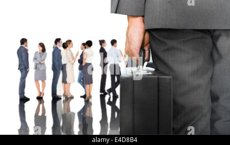 Composite image of businessman holding briefcase Stock Photo