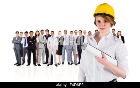 Composite image of pretty young architect smiling at camera Stock Photo