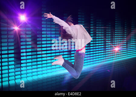 Composite image of cheerful young woman jumping Stock Photo