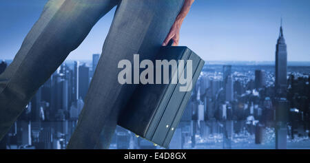 Composite image of businessman holding briefcase Stock Photo