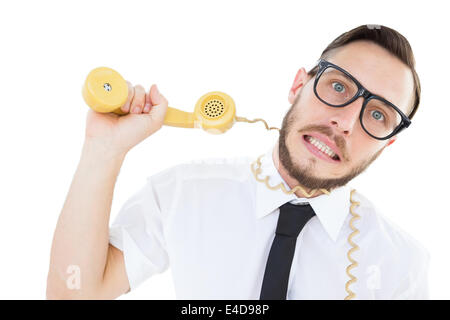 Geeky businessman being strangled by phone cord Stock Photo