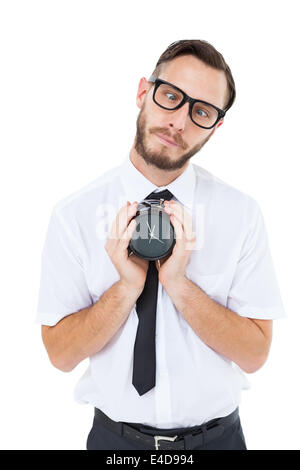 Geeky businessman holding alarm clock Stock Photo