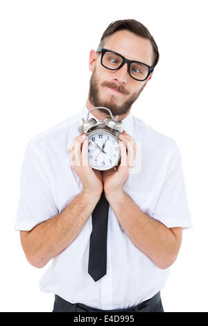 Geeky businessman holding alarm clock Stock Photo