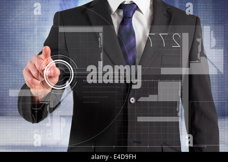 Composite image of businessman in suit pointing finger at interface Stock Photo