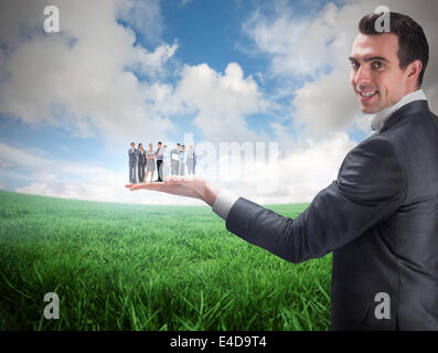 Composite image of businessman holding business team Stock Photo