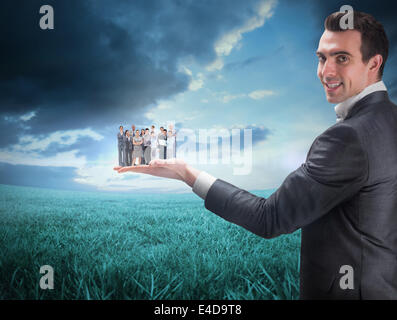 Composite image of businessman holding business team Stock Photo