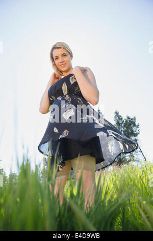 Pretty blonde in sundress smiling at camera Stock Photo