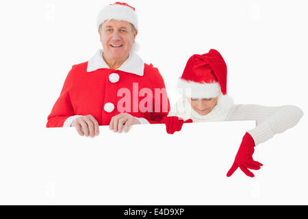 Festive older couple smiling and holding poster Stock Photo