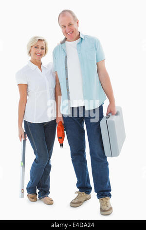 Happy older couple holding diy tools Stock Photo