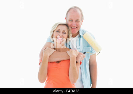 Happy older couple holding paint roller Stock Photo