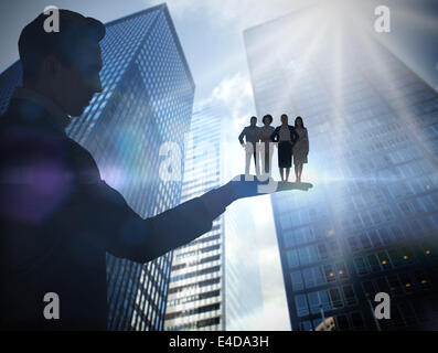 Composite image of businessman holding business team Stock Photo