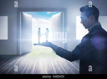 Composite image of businessman holding business partners Stock Photo