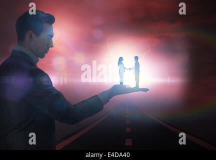 Composite image of businessman holding business partners Stock Photo