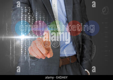 Businessman touching the words email marketing on interface Stock Photo