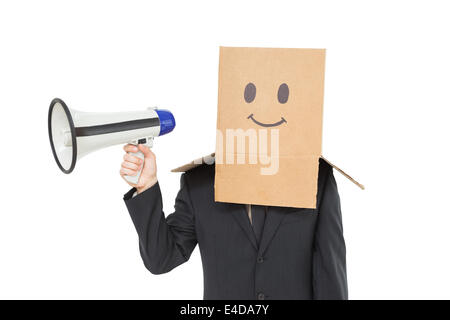 Businessman with box on head holding megaphone Stock Photo