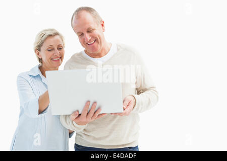 Happy mature couple using laptop Stock Photo