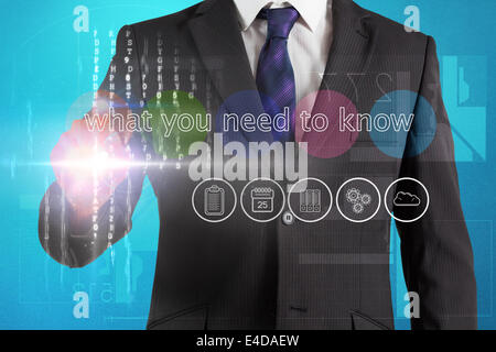 Businessman touching the words what you need to know on interface Stock Photo