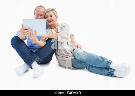 Happy mature couple using tablet pc Stock Photo