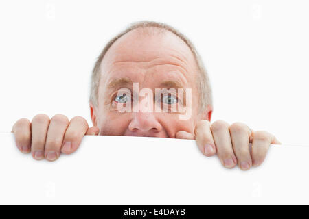 Mature man looking over card Stock Photo