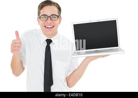 Geeky businessman holding his laptop showing thumbs up Stock Photo