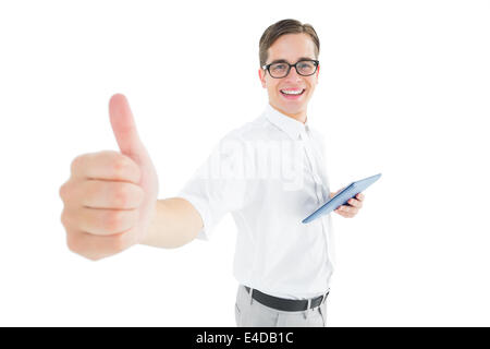 Geeky businessman holding his tablet showing thumbs up Stock Photo
