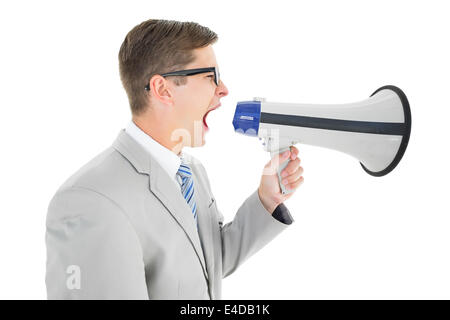 Geeky businessman shouting through megaphone Stock Photo