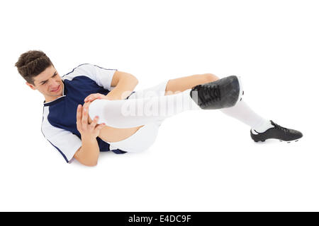 Football player lying down injured Stock Photo