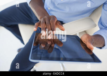 Businessman using his tablet pc Stock Photo