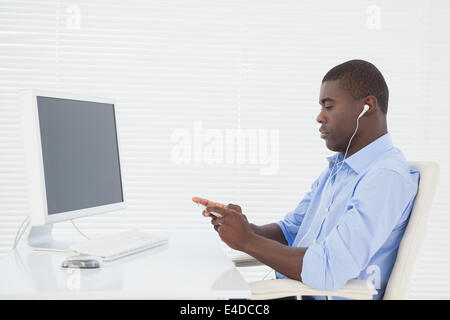 Businessman listening to music while he works Stock Photo