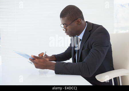 Serious businessman working with his tablet Stock Photo