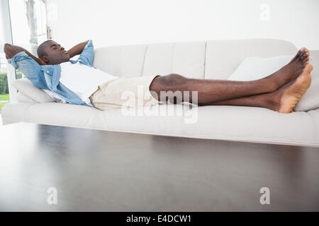 Casual man sleeping on his sofa Stock Photo