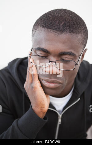 Casual man sitting on his sofa wearing glasses Stock Photo