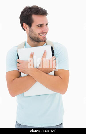 Handsome student carrying notepad and backpack Stock Photo