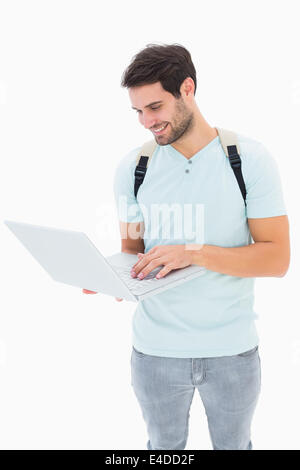 Handsome student using his laptop Stock Photo