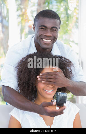 Man covering the eyes of his girlfriend while preparing proposal Stock Photo