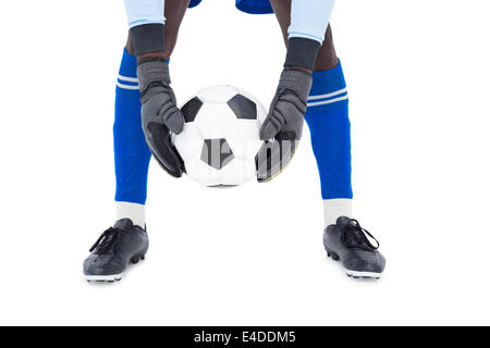 Goalkeeper in blue making a save Stock Photo