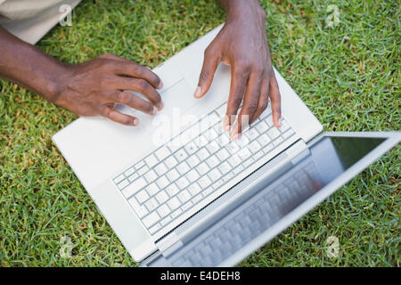 Man relaxing in his garden using laptop Stock Photo