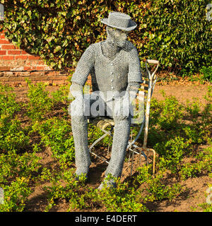 A wire sculpture entitled 'The Gardener' - by Derek Kinzett. Situated in The Rose Garden at Newstead Abbey, Nottinghamshire, UK Stock Photo