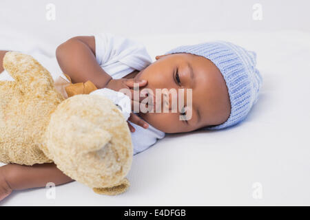 Adorable baby boy sleeping peacefully with teddy Stock Photo