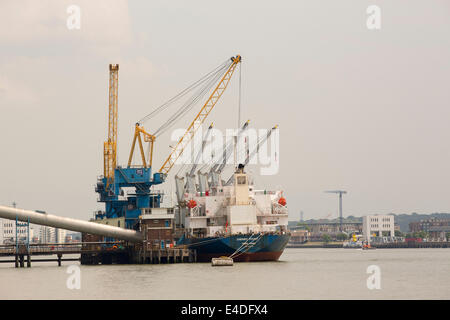A boat unloading sugar at the Tate and Lyle factory on the Thames in London, UK. Stock Photo