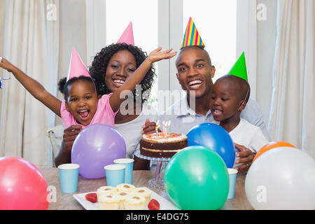 Happy family celebrating a birthday together at table Stock Photo