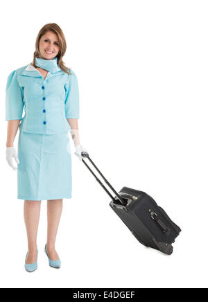 Portrait of stewardess in blue uniform with her bag Stock Photo