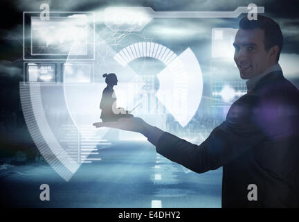Composite image of businesswoman using laptop Stock Photo