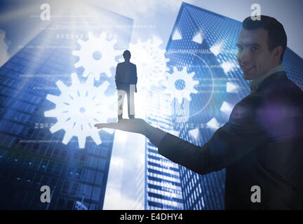 Composite image of smiling attractive architect on phone holding plans Stock Photo