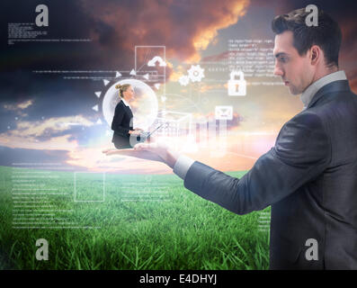 Composite image of businesswoman using laptop Stock Photo