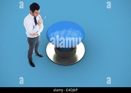 Composite image of unsmiling businessman holding glasses Stock Photo