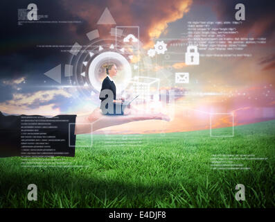 Composite image of businesswoman using laptop Stock Photo