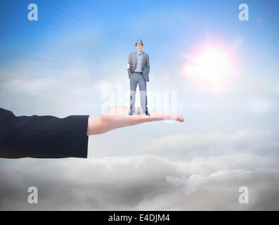 Composite image of smiling attractive architect on phone holding plans Stock Photo