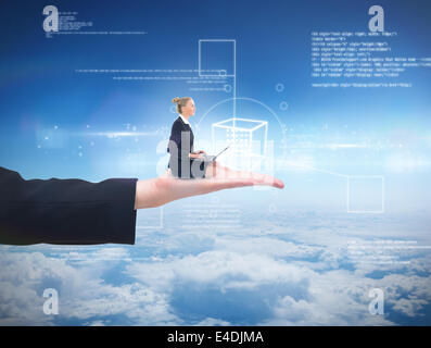 Composite image of businesswoman using laptop Stock Photo